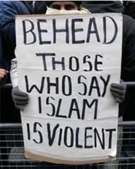 Muslim holding poster saying, Behead those that insult islam