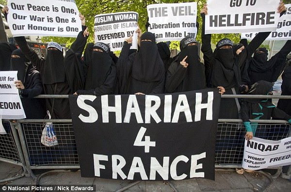 berka covered muslims holding sign. Shariah 4 franc